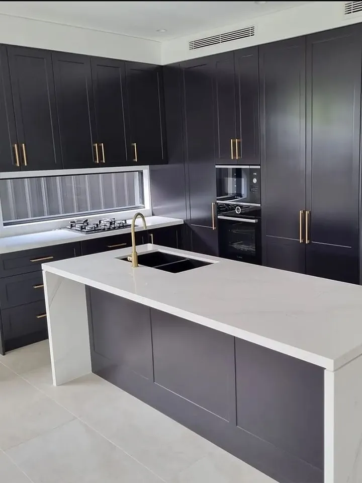 Kitchen renovation, Gold handles, gold kitchen handles, gold kitchen accessories, gold kitchen finishes, double kitchen sink, black double sink, shaker kitchen cabinetry, stone bench top, waterfall stone bench top, stone bench top panels